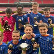 The team with their trophies on the Wembley pitch PIX: Oldham Athletic Community Trust