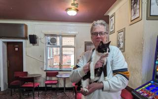 Pub landlord Jack Dodd holding cat Felix