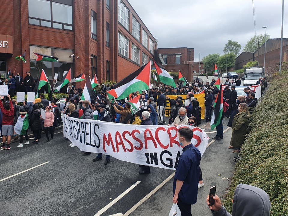Protesters outside the factory (Picture: Oldham Peace and Justice)