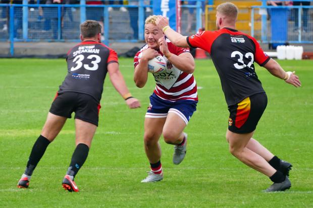 Tyler Dupree faces up to two Dewsbury defenders. Pictures: Dave Naylor