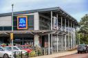 Messages have asked Aldi shoppers to unload their trolleys onto till belts and ensure carrier bags are empty
