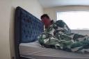 The part-time carer examined the footage that showed a mystery sleeper climbing into the bed.