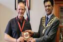 Steve Hill MBE being presented with The Borough's Coat of Arms by Mayor of Oldham Cllr Zahid Chauhan