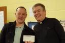 Greenacres Congregational Church minister Rev David Lampard presents a cheque to Martin Sutton from Oldham Young Carers.