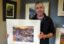 Artist Chris Cyprus with a limited edition oil painting