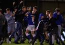 Latics fans rush onto the pitch to celebrate the penalty shoot-out win over Tranmere Rovers