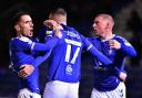 Callum Whelan, Jack Stobbs and Nicky Adams and celebrate Oldham's fifth goal