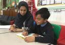 An Oldham Sixth Form College student buddies up with a pupil from Werneth Primary. Photo: Pinnacle Learning Trust