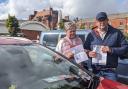 Martin and Jackie standing with their blue badge and parking fine letters in an unrelated car park, as they pledged not to return to Elk Mill