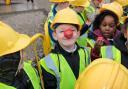 The pupils wore hard hats and hi-vis vests for safety - and their red noses for Red Nose Day