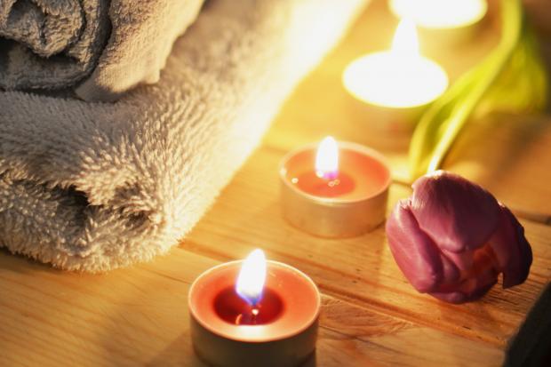 The Oldham Times: A pile of towels, candles and a tulip. Credit: Canva