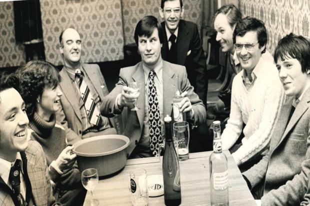 FUN: Wine taster Malcolm Potts, centre, samples Mr Ben’s worst home-made wine competition at the Balmoral Hotel in Bolton in 1979