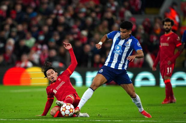 Porto winger Luis Diaz is tackled by Liverpool's Takumi Minamino