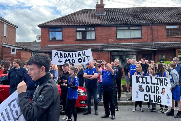 Fans held signs and banners calling for the club's ownership team to leave