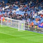 Latics fans hold up a banner during their 3-0 defeat at home to Barrow