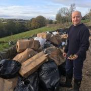 Holme Valley farmer Heath Ramsden with an entire cannabis farm that was dumped on his land. (Image: LDRS) FREE USE TO ALL NEWSWIRE PARTNERS