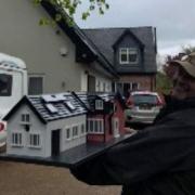 Mr Yates with the replica of a house in Knutsford.