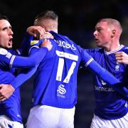 Callum Whelan, Jack Stobbs and Nicky Adams and celebrate Oldham's fifth goal