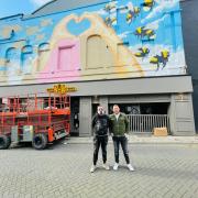 Painter Jamie Buckley and director Phil James in front of the mural as it nears completion.