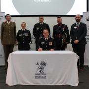 Chief Fire Officer Dave Russel, centre, signing the covenant