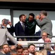 Wrexham co-owner Ryan Reynolds (centre) speaks to David Beckham and Will Ferrell in the stands ahead of the Buildbase FA Trophy final at Wembley Stadium