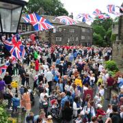 Villagers gather in Dobcross Square for a service before setting off to join other churches in their Whit Walk to Uppermill (Pictures Paul Clegg and Laura-Daisy Bennett)