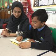 An Oldham Sixth Form College student buddies up with a pupil from Werneth Primary. Photo: Pinnacle Learning Trust