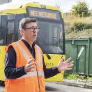 Mayor Andy Burnham standing in front of the newest tram