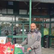 Zafar Iqbal, Morrison's Community Champion donates food to the charity