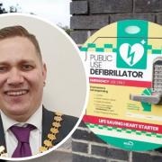 Defib with inset picture of Cllr Louie Hamblett