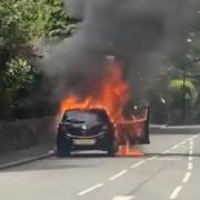 The car was seen engulfed in flames on a road in Shaw yesterday