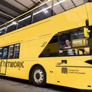 Mayor Andy Burnham pictured on a yellow Bee Network bus