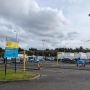 The entrance to the car park with trailers in background