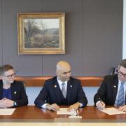 Left to right: Manchester Council leader Cllr Bev Craig, Chief Technology Officer at Fujitsu Vivek Mahajan, and Greater Manchester Mayor Andy Burnham, sign the agreement in Tokyo