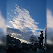 The picture Julia Bowers took of a statue of a soldier at Chadderton Town Hall overlooking a cloud in a formation of Great Britain