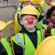 The pupils wore hard hats and hi-vis vests for safety - and their red noses for Red Nose Day
