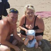 Vincent McDonagh pictured at the beach with his fiance Demis Leigh Sykes and their child Frankie
