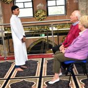 Ehsan Tahir recites a poem to visitors Peter and Judith Killan during an open day at Greengate Jamia Masjid, Oldham.