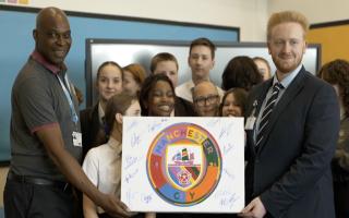 Former City goalkeeper Alex Williams presents a signed canvas to the Pride Club. Photo: Manchester City/City in the Community