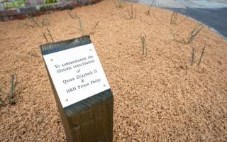 A plaque commemorates the late monarch and prince