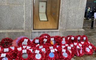 Poppy wreaths below the war memorial
