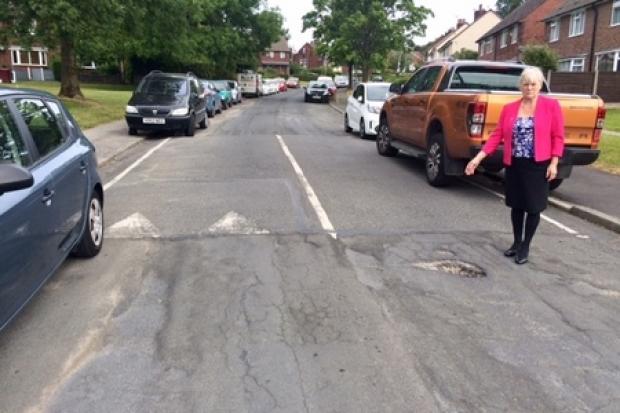 RESURFACING: Cllr Joyce Kellett with a pothole in Makinson Avenue, Horwich